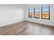 Bright bedroom with hardwood floors and large windows with outdoor views at 3909 Piney Grove St, Evergreen, CO 80439