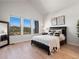 Bright bedroom featuring large windows with a beautiful nature view and modern decor at 3909 Piney Grove St, Evergreen, CO 80439