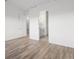 Spacious bedroom with hardwood floors and doors leading to the bathroom and walk-in closet at 3909 Piney Grove St, Evergreen, CO 80439