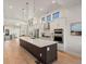 Well-lit kitchen featuring a large island, stainless steel appliances, and sleek cabinetry at 3909 Piney Grove St, Evergreen, CO 80439