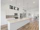 Modern kitchen features large island, stainless appliances, and bright pendant lighting at 3909 Piney Grove St, Evergreen, CO 80439