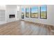 Stylish living room with modern fireplace, built-in shelves, and great views from large windows at 3909 Piney Grove St, Evergreen, CO 80439