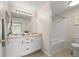 Well-lit bathroom features a dual sink vanity and a separate shower/tub area at 7440 S Blackhawk St # 2-108, Englewood, CO 80112