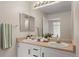 Bathroom featuring double vanity, large mirror, and view into bedroom at 7440 S Blackhawk St # 2-108, Englewood, CO 80112