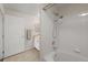Clean bathroom with tub and shower features bright white tile and modern fixtures at 7440 S Blackhawk St # 2-108, Englewood, CO 80112