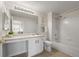 Bright bathroom with a large mirror, vanity, lighting fixture, and shower-tub combo at 7440 S Blackhawk St # 2-108, Englewood, CO 80112
