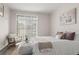 Bright bedroom features neutral decor, cozy textures, and ample natural light from sliding glass door at 7440 S Blackhawk St # 2-108, Englewood, CO 80112
