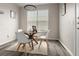 Bright dining area features wood table, stylish chairs, modern light fixture, and neutral tones at 7440 S Blackhawk St # 2-108, Englewood, CO 80112