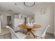 Open-concept dining area with wood table, stylish chairs, modern light fixture, and neutral tones at 7440 S Blackhawk St # 2-108, Englewood, CO 80112