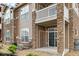 Exterior of building with a stone facade and a balcony at 7440 S Blackhawk St # 2-108, Englewood, CO 80112