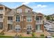 Exterior view showcasing a three-story condo with stone accents and private balconies at 7440 S Blackhawk St # 2-108, Englewood, CO 80112