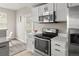 Bright kitchen features stainless steel appliances and white cabinets, creating a modern and clean space at 7440 S Blackhawk St # 2-108, Englewood, CO 80112