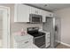 Contemporary kitchen featuring stainless steel appliances and white cabinetry for a sleek look at 7440 S Blackhawk St # 2-108, Englewood, CO 80112