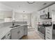 Bright kitchen features white countertops, stainless steel appliances, and seamless flow to the living space at 7440 S Blackhawk St # 2-108, Englewood, CO 80112