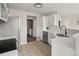 Modern kitchen featuring stainless steel appliances and white cabinets, seamlessly connecting to the laundry room at 7440 S Blackhawk St # 2-108, Englewood, CO 80112