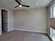 Spacious bedroom with ceiling fan and large window at 5021 S Prince Pl, Littleton, CO 80123