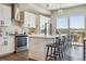 Modern kitchen with white cabinets, stainless steel appliances, and hardwood floors at 5021 S Prince Pl, Littleton, CO 80123