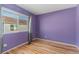 Purple accent wall bedroom with hardwood floors and window at 19813 E 47Th Ave, Denver, CO 80249