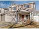 Two-story house with attached garage and landscaping at 19813 E 47Th Ave, Denver, CO 80249