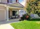 Charming house exterior featuring a covered porch, well-manicured lawn, and mature landscaping at 19813 E 47Th Ave, Denver, CO 80249