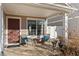 Covered front porch with seating and a view of the yard at 19813 E 47Th Ave, Denver, CO 80249