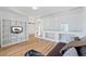 Bright Gathering room featuring hardwood floors and built-in shelving at 19813 E 47Th Ave, Denver, CO 80249