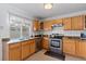 Kitchen features stainless steel appliances and wood cabinets at 19813 E 47Th Ave, Denver, CO 80249