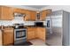 Kitchen boasts stainless steel appliances and wood cabinets at 19813 E 47Th Ave, Denver, CO 80249