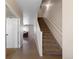 View of hallway with carpeted stairs, hardwood floors and neutral wall colors at 7774 E 137Th Ave, Thornton, CO 80602