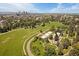 Wide aerial view of a park and the city skyline, showcasing the lush green space and urban environment at 1356 N Marion St, Denver, CO 80218