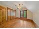 Bedroom with hardwood floors, trim, a window, and a closet at 1356 N Marion St, Denver, CO 80218