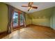 Bedroom with hardwood floors, a ceiling fan, and access to a deck at 1356 N Marion St, Denver, CO 80218
