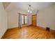 Bedroom featuring hardwood floors, a window with curtains, and wood trim at 1356 N Marion St, Denver, CO 80218
