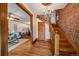 Inviting entryway with hardwood floors, wooden staircase with exposed brick, and chandelier lighting at 1356 N Marion St, Denver, CO 80218