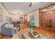 Open-concept living room and dining area boasts hardwood floors, chandelier, and plenty of natural light at 1356 N Marion St, Denver, CO 80218