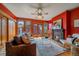 Cozy living room with fireplace, hardwood floors, a ceiling fan, and direct access to an outdoor space at 1356 N Marion St, Denver, CO 80218