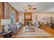 Bright living room featuring a decorative fireplace, hardwood floors, and stylish furnishings for cozy appeal at 1356 N Marion St, Denver, CO 80218