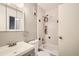 Cozy bathroom with white tiled shower, modern fixtures, white vanity and accent mosaic tile at 12935 W 64Th Dr # D, Arvada, CO 80004