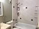 Bathroom featuring shower-tub combo with a white tiled surround at 12935 W 64Th Dr # D, Arvada, CO 80004