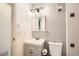Well-lit bathroom featuring a modern vanity with storage and a toilet, designed for convenience and everyday use at 12935 W 64Th Dr # D, Arvada, CO 80004