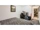Cozy bedroom featuring a dedicated workspace with desk, chair, and neutral gray walls and carpet at 12935 W 64Th Dr # D, Arvada, CO 80004