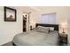 Bedroom featuring a comfortable bed, closet, and window providing natural light at 12935 W 64Th Dr # D, Arvada, CO 80004
