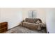 Simple bedroom with neutral carpet and a cozy couch, ideal for relaxation or a quiet retreat in a minimalist setting at 12935 W 64Th Dr # D, Arvada, CO 80004