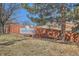 Autumn Wood Townhomes community sign with wooden fence and landscaped greenery at 12935 W 64Th Dr # D, Arvada, CO 80004