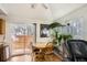 Cozy dining area features a round table, patio access, and a tranquil indoor plant display, offering a blend of indoor and outdoor living at 12935 W 64Th Dr # D, Arvada, CO 80004