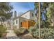 Exterior view of the home showcasing a wood privacy fence, siding, and well-maintained landscaping at 12935 W 64Th Dr # D, Arvada, CO 80004