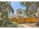 Side view of the home with a wooden fence and well-maintained landscaping at 12935 W 64Th Dr # D, Arvada, CO 80004