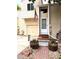 Charming home entrance with a wooden door, American flag, and decorative flower pots at 12935 W 64Th Dr # D, Arvada, CO 80004