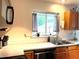 Kitchen sink area with modern fixtures, neutral countertops, and subway tile backsplash at 12935 W 64Th Dr # D, Arvada, CO 80004