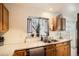 The Kitchen sink, with oak cabinets and a window at 12935 W 64Th Dr # D, Arvada, CO 80004